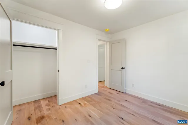 a kitchen with white cabinets and a window