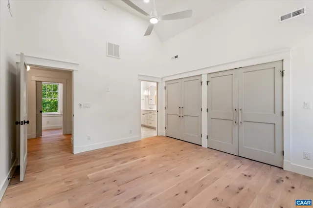 an empty room with windows and closet