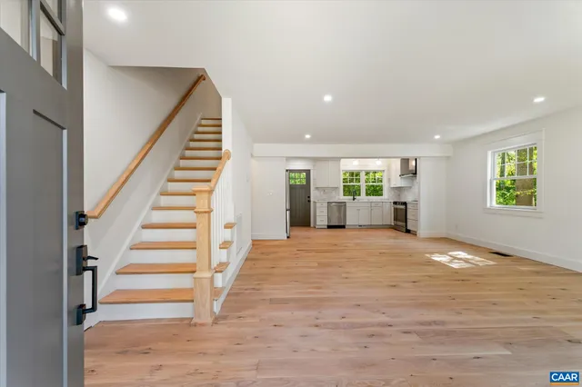 an empty room with windows and entrance