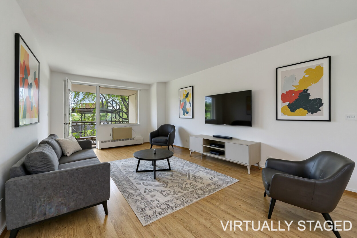 a living room with furniture a rug and a flat screen tv