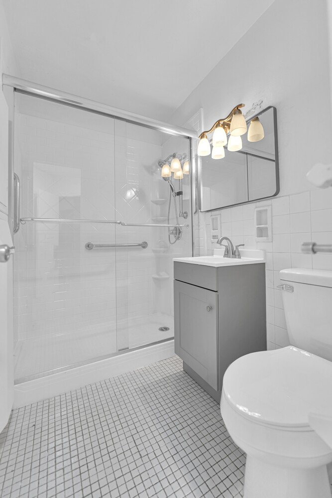 5800 Arlington Avenue, Unit 2R Bronx, NY 10471 - Photo 4 of 19 a bathroom with a sink a toilet and shower