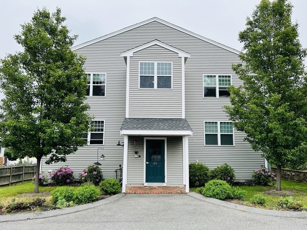 39 Athens Street, Unit 1 Weymouth, MA 02191 - Photo 1 of 13 a front view of a house with a garden