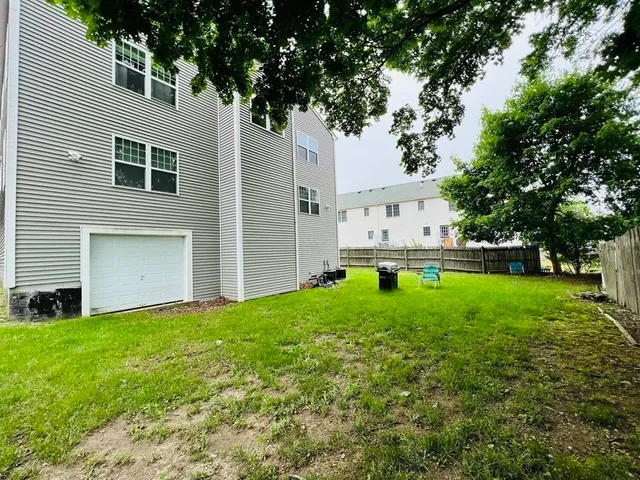 a backyard of a house with table and chairs
