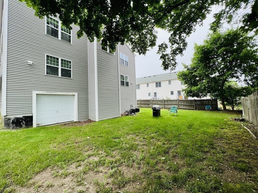 39 Athens Street, Unit 1 Weymouth, MA 02191 - Photo 11 of 13 a white house that has tree in front of it