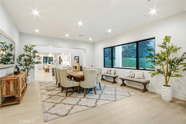 a living room with furniture a dining table and a flat screen tv