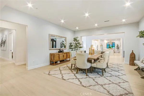a living room with furniture floor to ceiling window and a flat screen tv