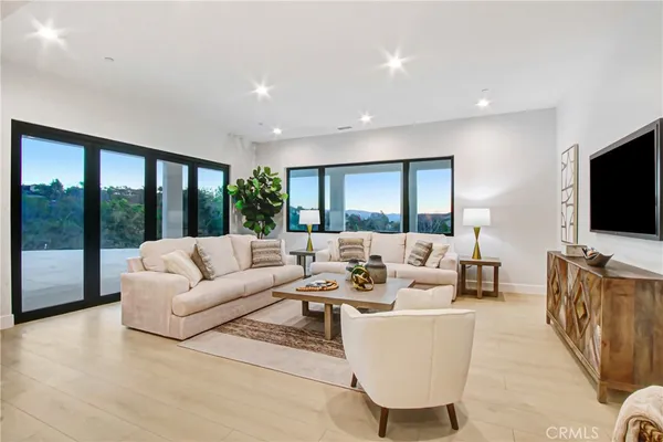 a living room with furniture and a large window