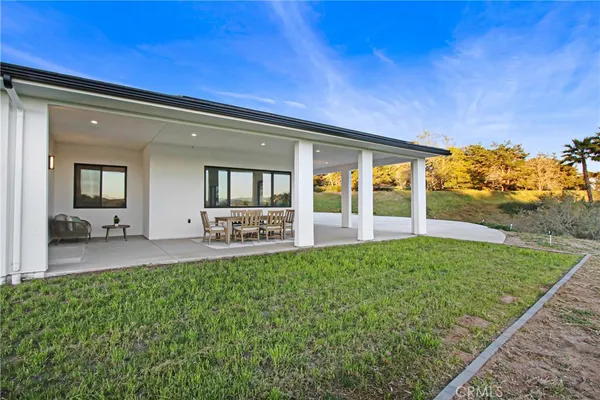 a front view of house with yard and outdoor seating