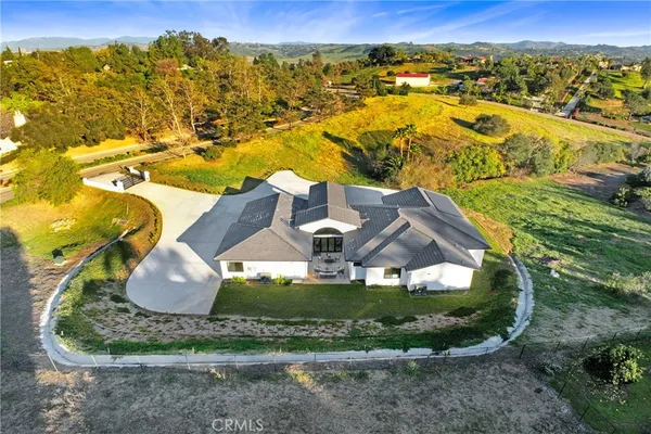 an aerial view of a house with a swimming pool