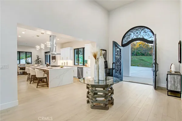 a living room with furniture a fireplace and a floor to ceiling window