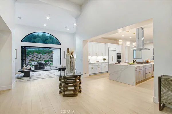 a large white kitchen with a large window