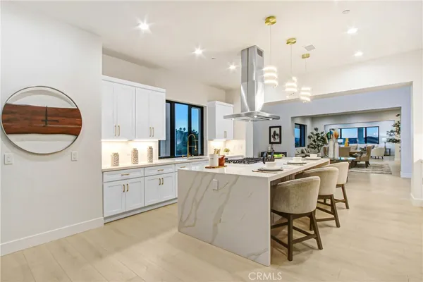 a kitchen with kitchen island granite countertop a table and chairs