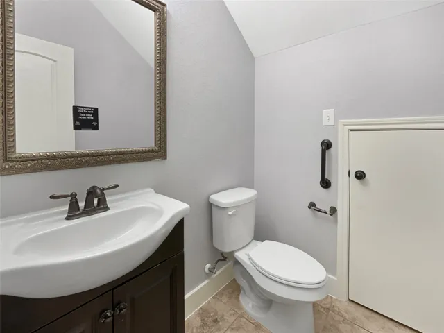 a bathroom with a sink toilet and mirror