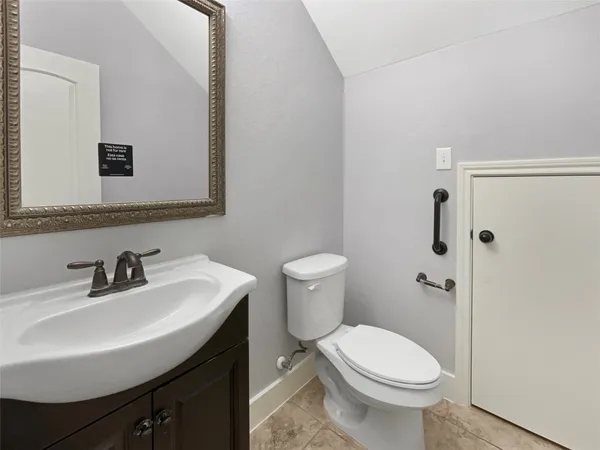 a bathroom with a sink toilet and mirror