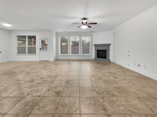 a view of an empty room with a fireplace and a window
