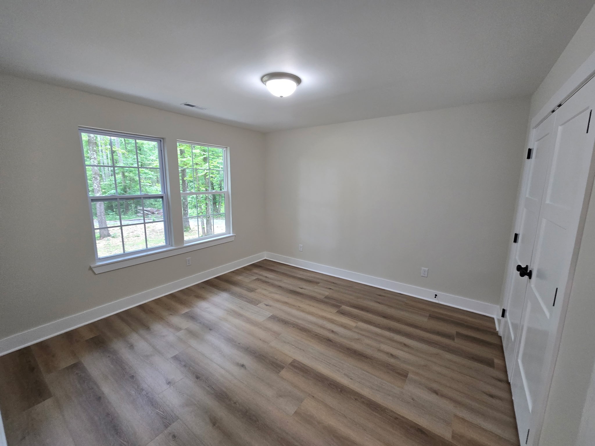 841 Lucas Road Dickson, TN 37055 - Photo 18 of 21 a view of an empty room with wooden floor and a window