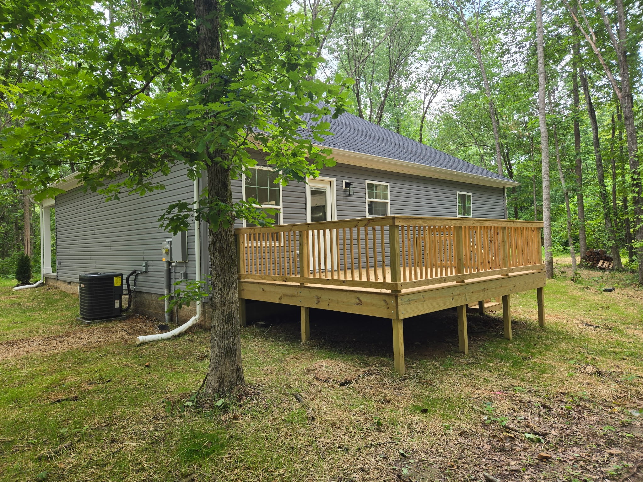 841 Lucas Road Dickson, TN 37055 - Photo 20 of 21 a view of a house with a backyard and wooden deck