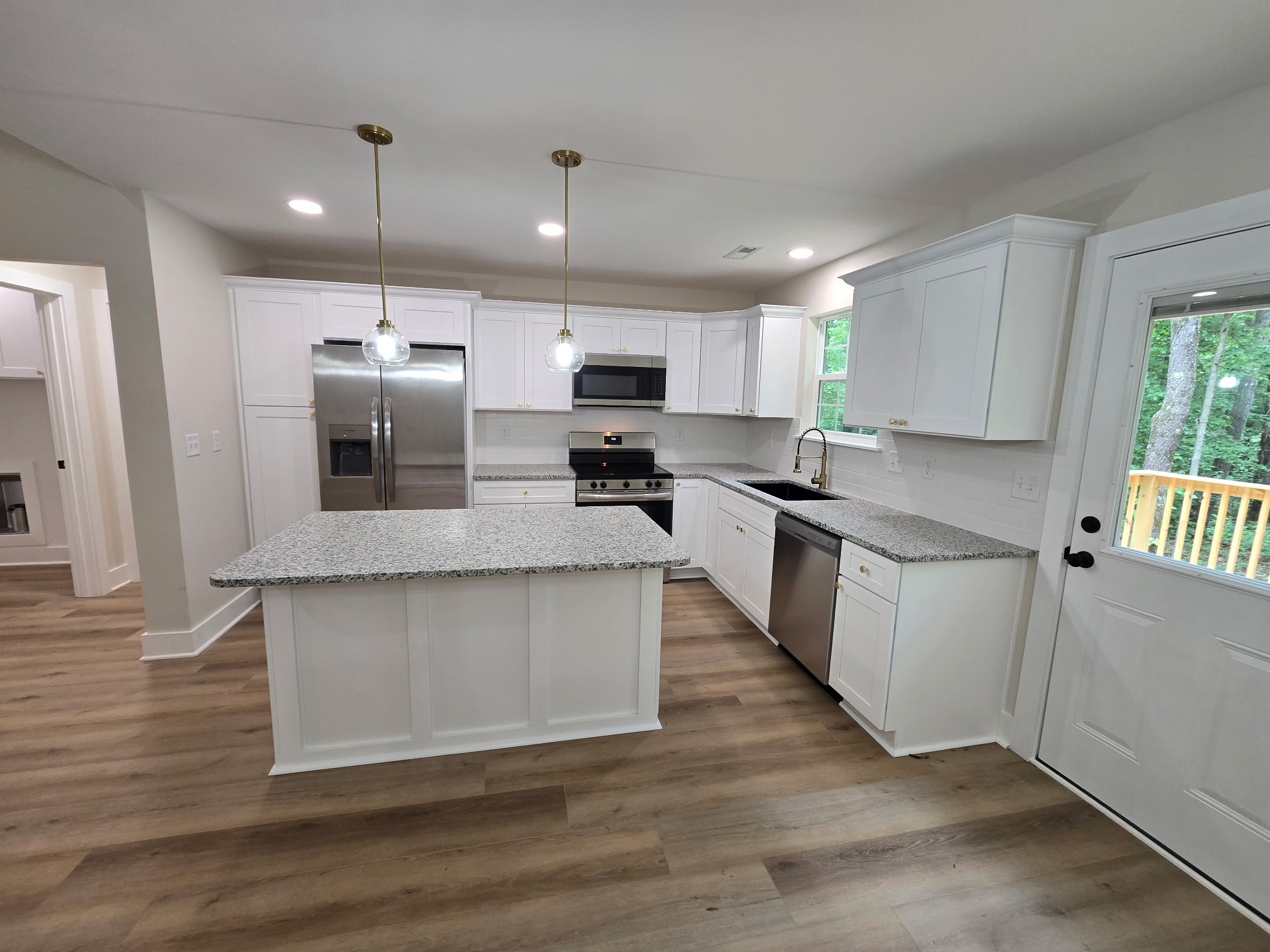 841 Lucas Road Dickson, TN 37055 - Photo 8 of 21 a large kitchen with stainless steel appliances granite countertop a stove a sink and a refrigerator