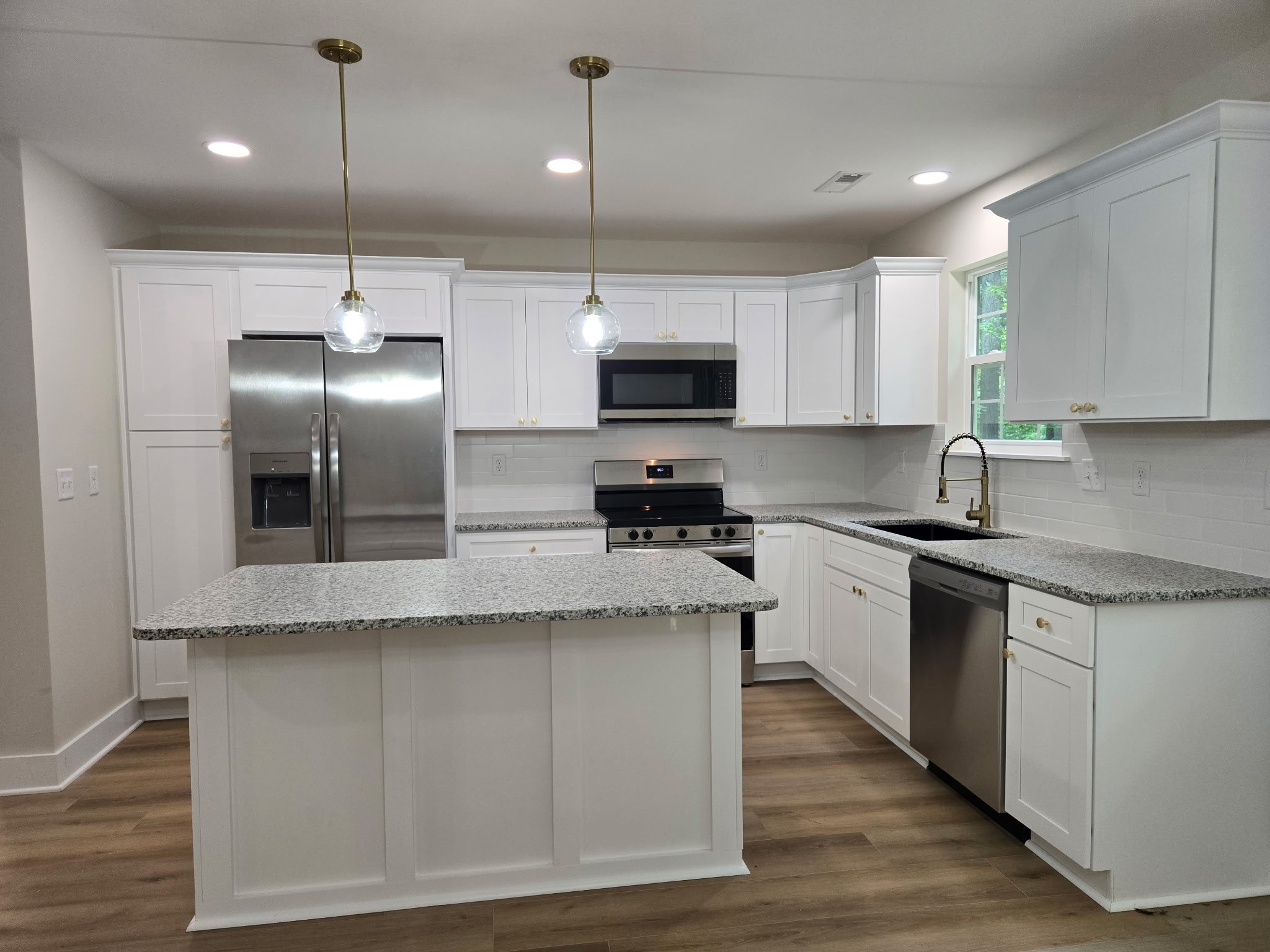 841 Lucas Road Dickson, TN 37055 - Photo 9 of 21 a kitchen with stainless steel appliances granite countertop a sink a stove and a refrigerator