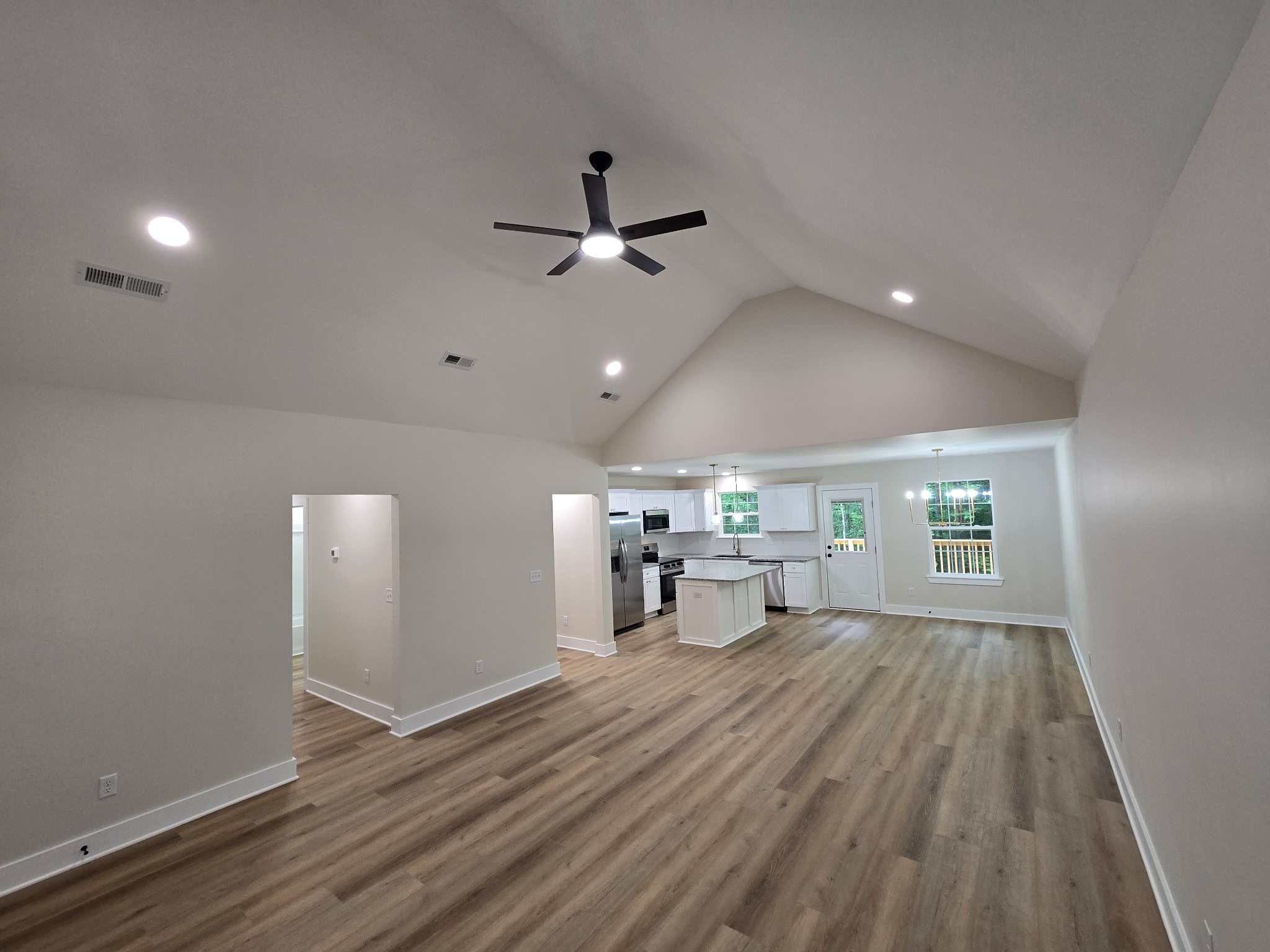 841 Lucas Road Dickson, TN 37055 - Photo 10 of 21 a view of a room with wooden floor a ceiling fan and windows