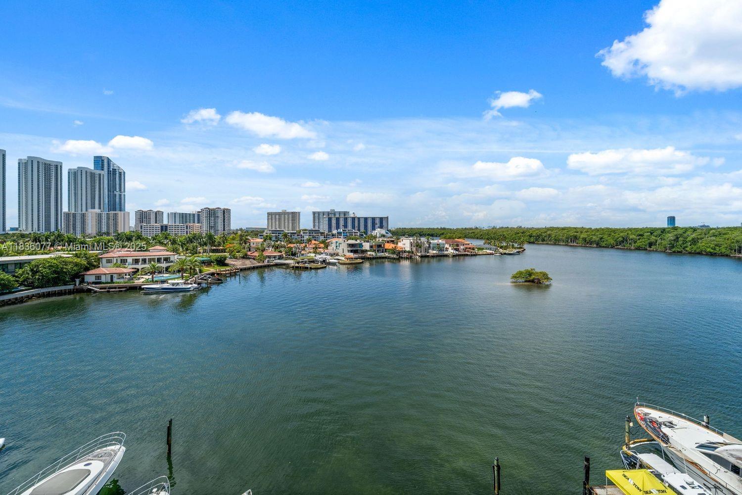400 Sunny Isles Boulevard, Unit 616 Sunny Isles Beach, FL 33160 - Photo 12 of 19 a view of a lake with houses