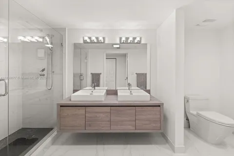 a bathroom with a sink toilet and shower