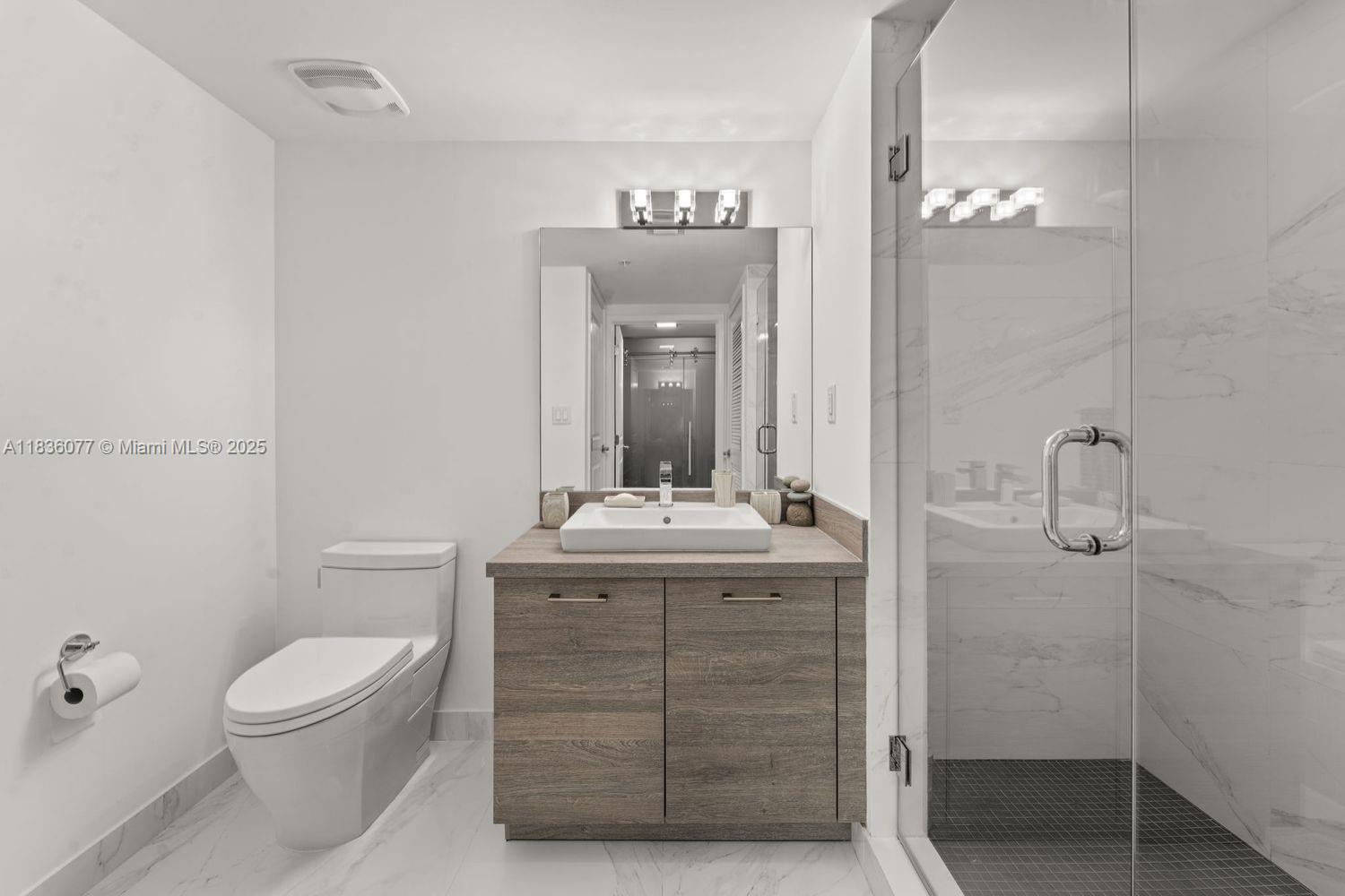 400 Sunny Isles Boulevard, Unit 616 Sunny Isles Beach, FL 33160 - Photo 7 of 19 a bathroom with a toilet a sink and mirror