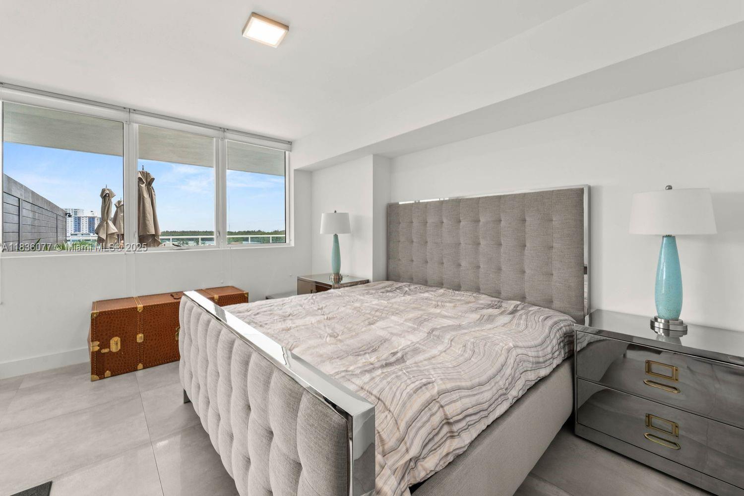 400 Sunny Isles Boulevard, Unit 616 Sunny Isles Beach, FL 33160 - Photo 8 of 19 a spacious bedroom with a bed and a dresser