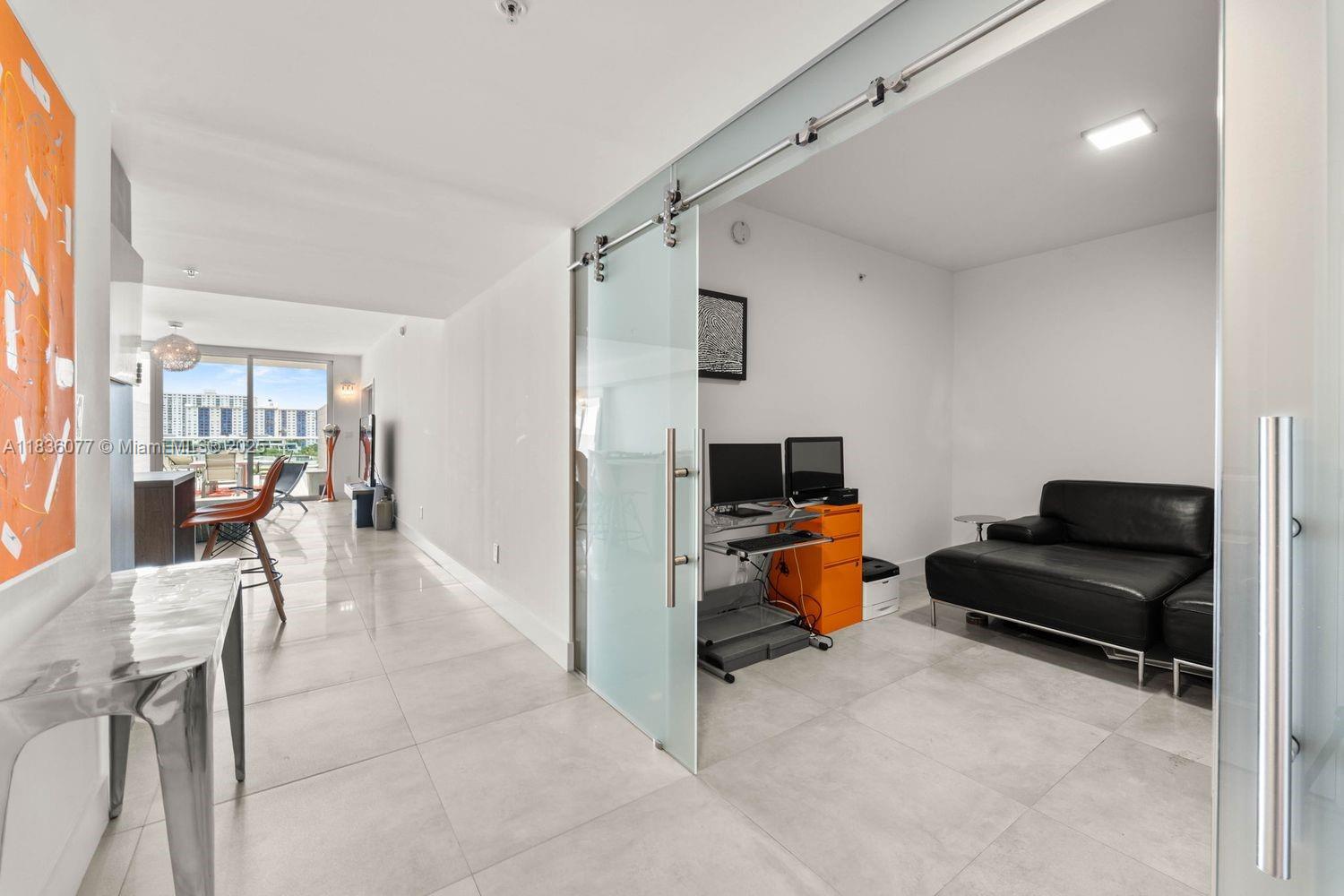400 Sunny Isles Boulevard, Unit 616 Sunny Isles Beach, FL 33160 - Photo 10 of 19 a living room with furniture and a flat screen tv