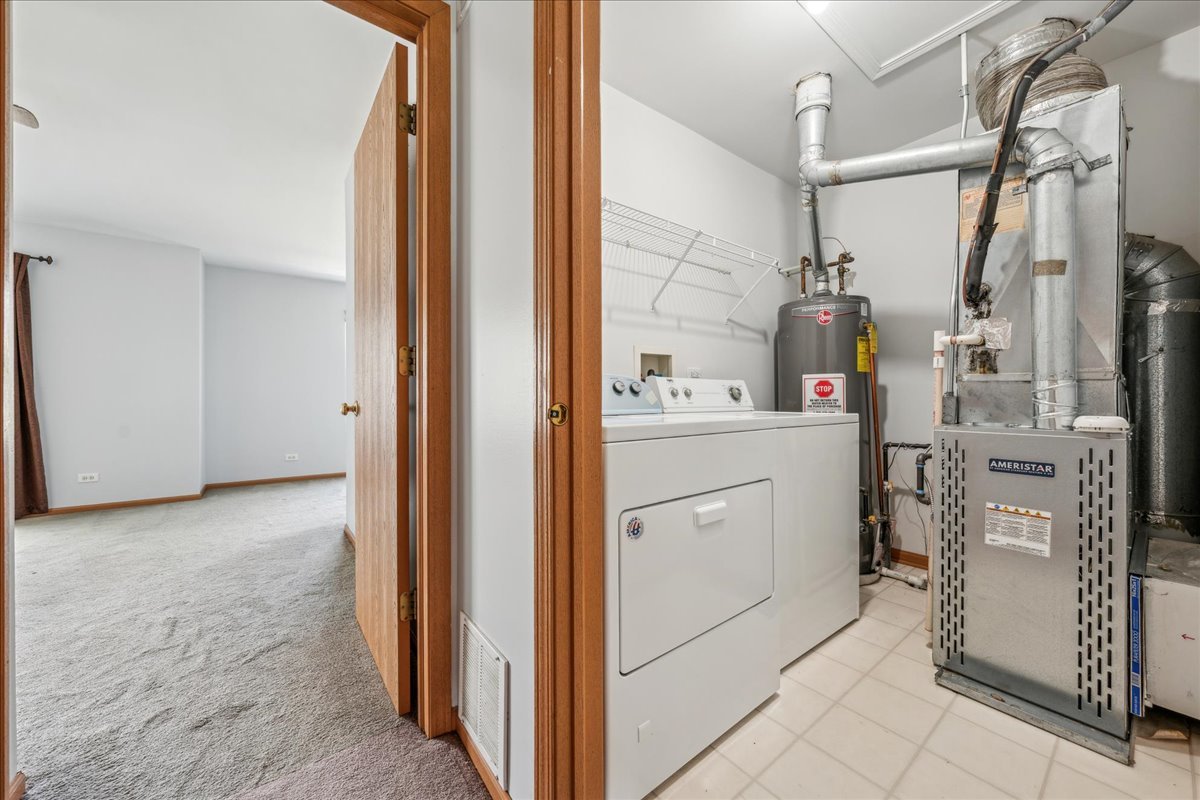746 County Line Road Aurora, IL 60502 - Photo 12 of 16 a view of a storage & utility room with closet dryer and washer