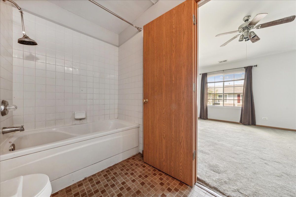 746 County Line Road Aurora, IL 60502 - Photo 16 of 16 a bathroom with a bathtub and a shower