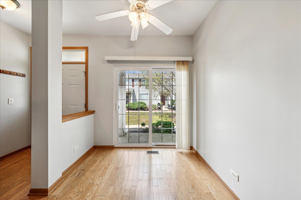 746 County Line Road Aurora, IL 60502 - Photo 4 of 16 an empty room with wooden floor fan and windows