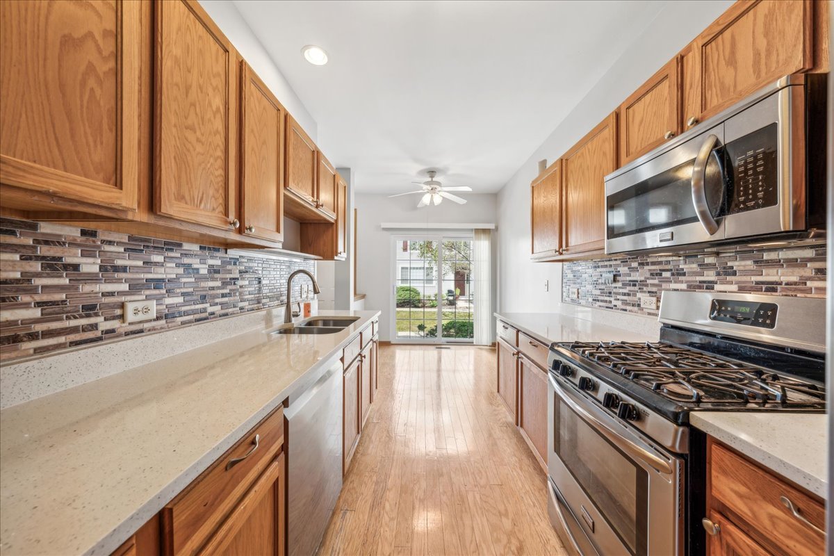 746 County Line Road Aurora, IL 60502 - Photo 5 of 16 a kitchen with stainless steel appliances granite countertop a stove a sink and a microwave