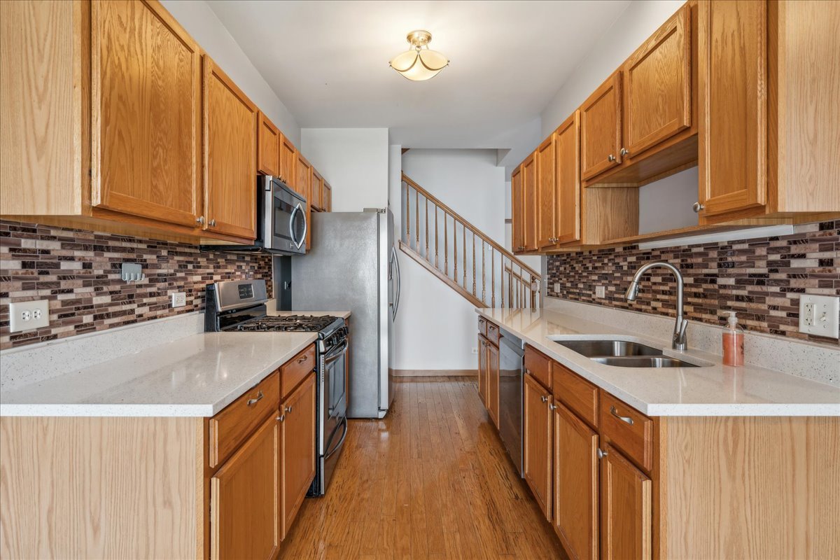 746 County Line Road Aurora, IL 60502 - Photo 6 of 16 a kitchen with sink a stove and cabinets