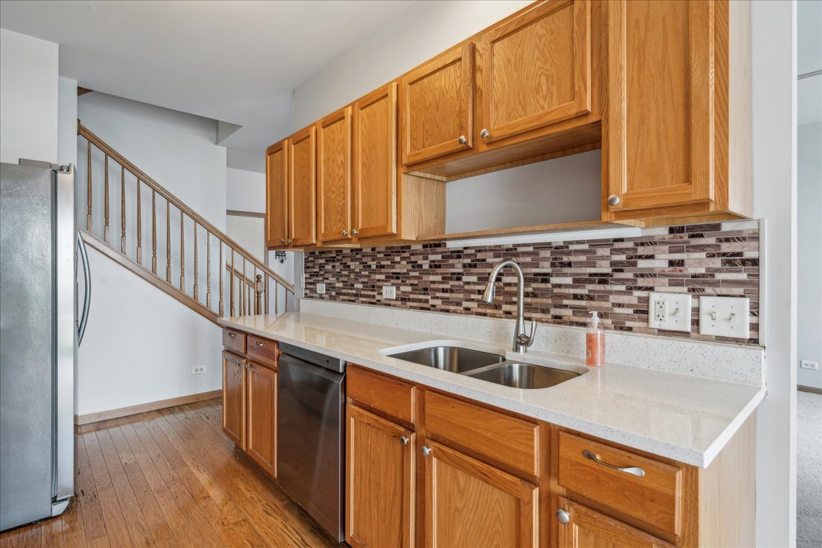 746 County Line Road Aurora, IL 60502 - Photo 7 of 16 a kitchen with granite countertop a sink and cabinets