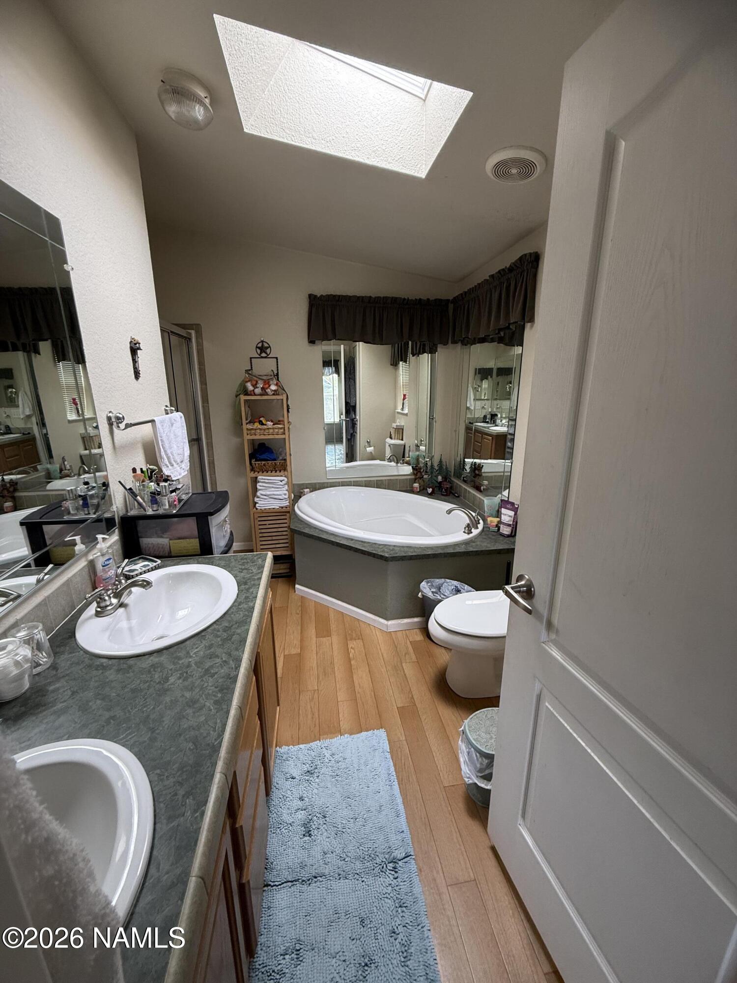 1431 East Cedar Road Williams, AZ 86046 - Photo 32 of 51 a bathroom with a granite countertop sink a toilet and a mirror