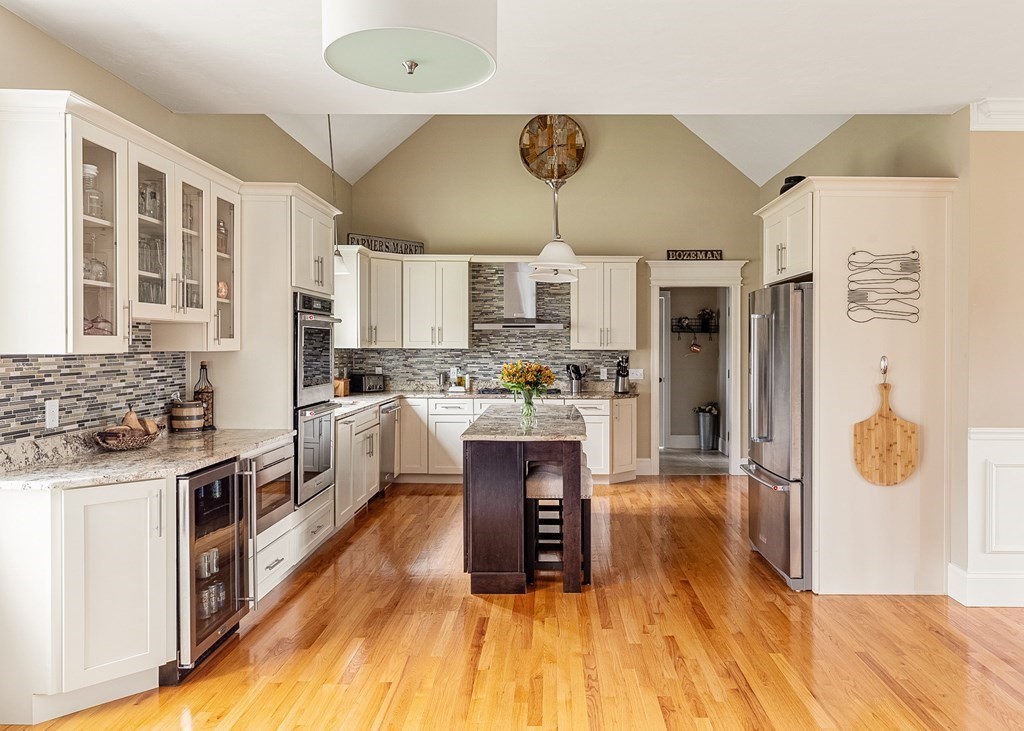 90 Armsby Road Sutton, MA 01590 - Photo 8 of 35 a kitchen with stainless steel appliances granite countertop a refrigerator a stove top oven and a sink
