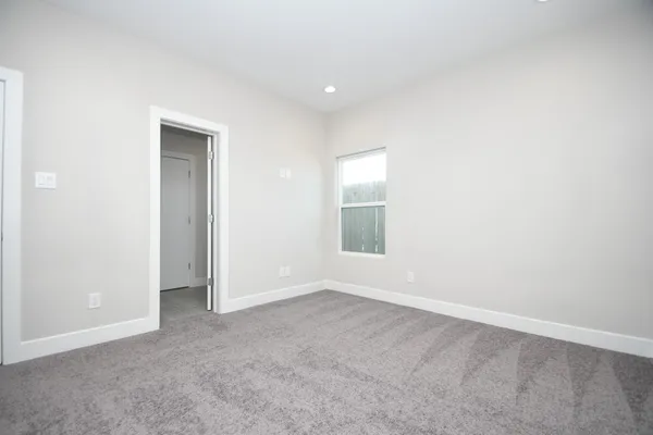 an empty room with a empty space and windows