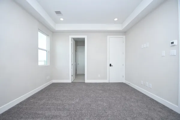 an empty room with windows and closet