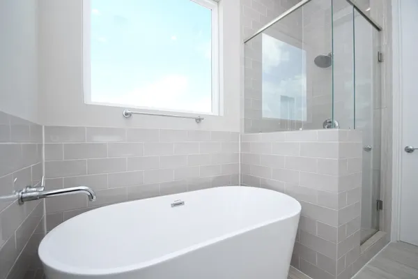 a white bath tub sitting next to a white toilet