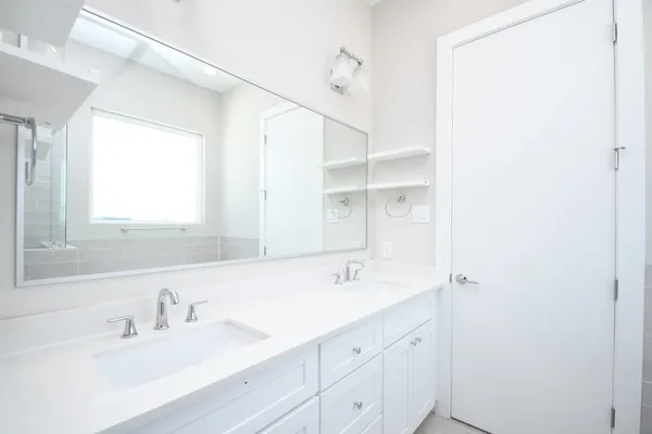 a bathroom with a sink double vanity and a mirror