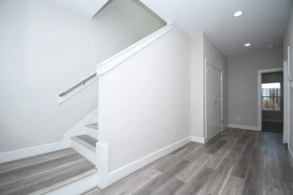 a view of entryway and hall with wooden floor