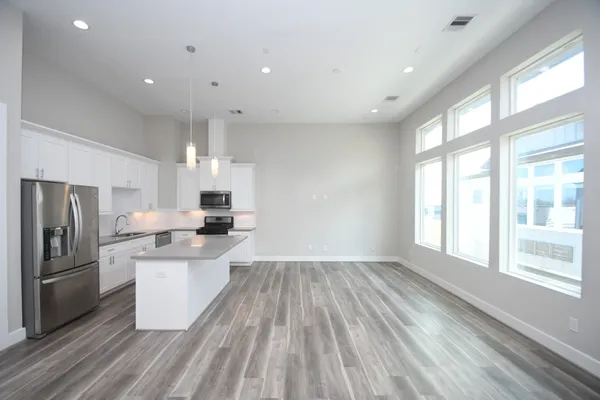 a kitchen with stainless steel appliances a refrigerator sink and cabinets