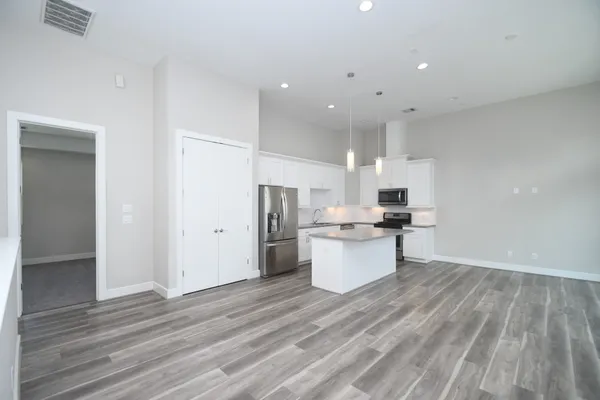 a kitchen with a sink and wooden floor