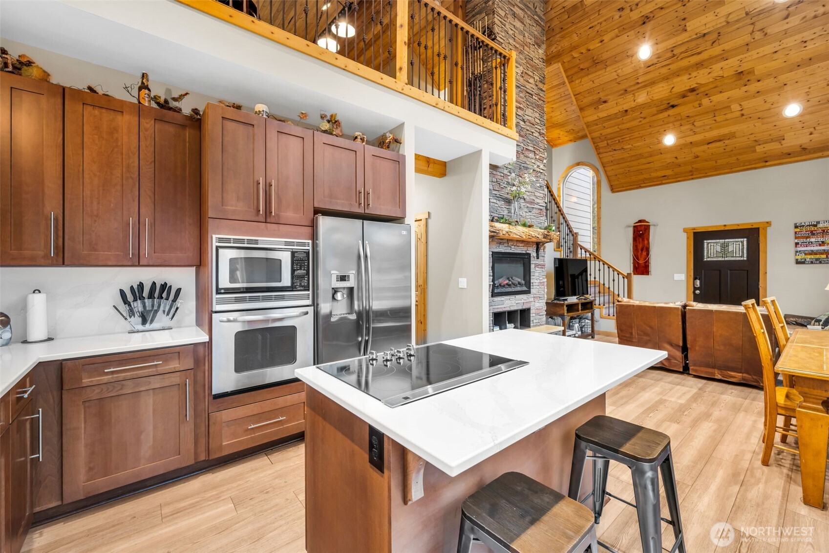 11650 Eagle Creek Road Leavenworth, WA 98826 - Photo 11 of 38 a kitchen that has a kitchen island a sink a stove and chairs