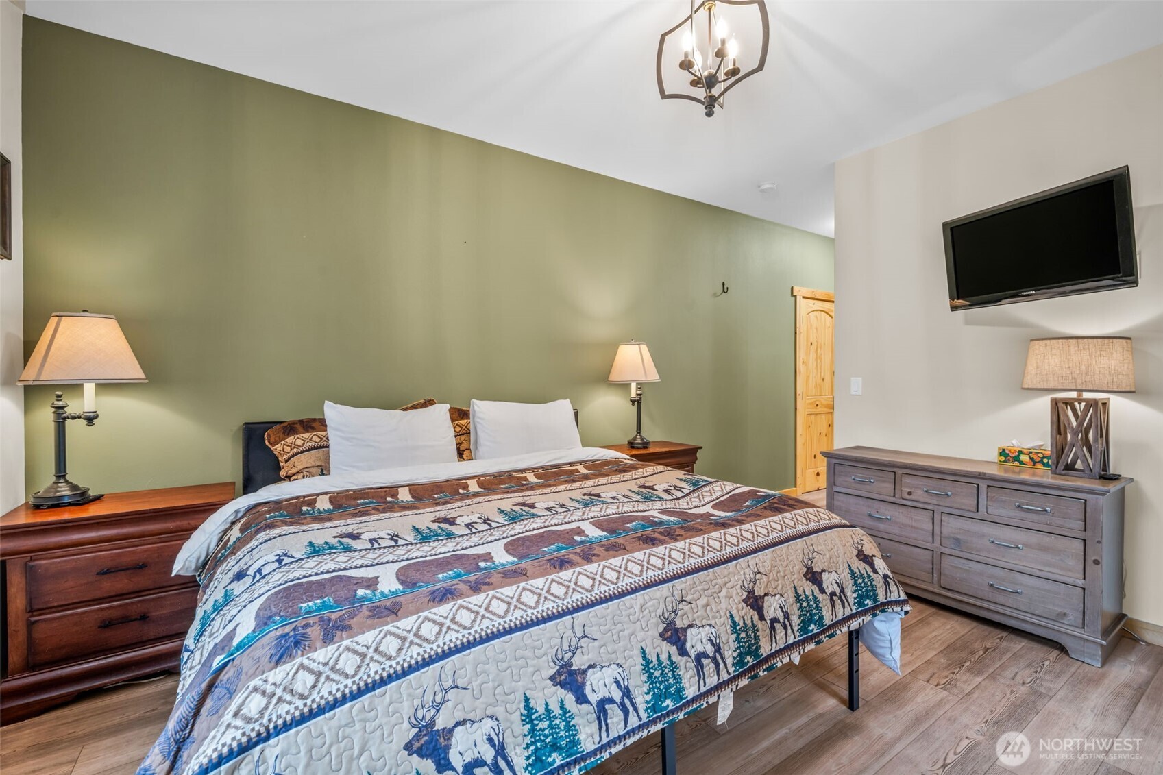 11650 Eagle Creek Road Leavenworth, WA 98826 - Photo 15 of 38 a bedroom with a bed and a flat tv screen on dresser