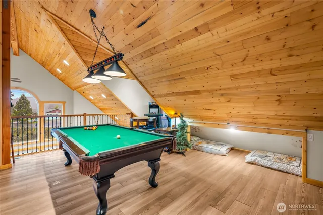 a room with pool table and windows