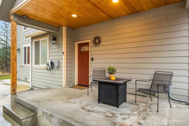 a backyard of a house with barbeque oven table and chairs