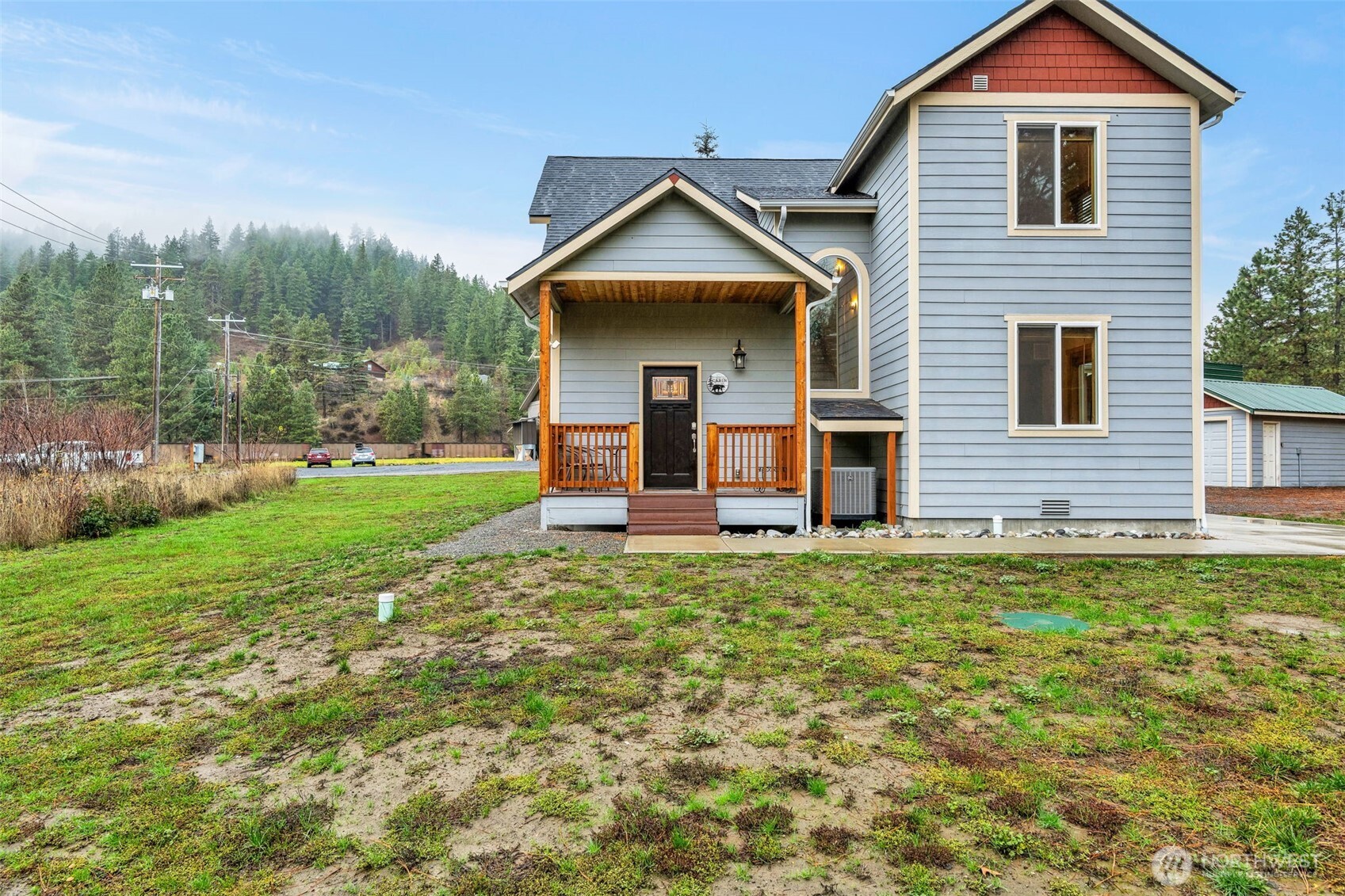 11650 Eagle Creek Road Leavenworth, WA 98826 - Photo 32 of 38 a view of a brick house with a yard and large trees
