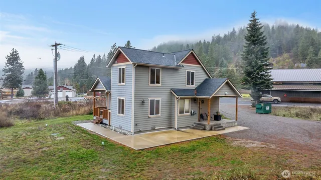 a view of a house with a yard patio and fire pit
